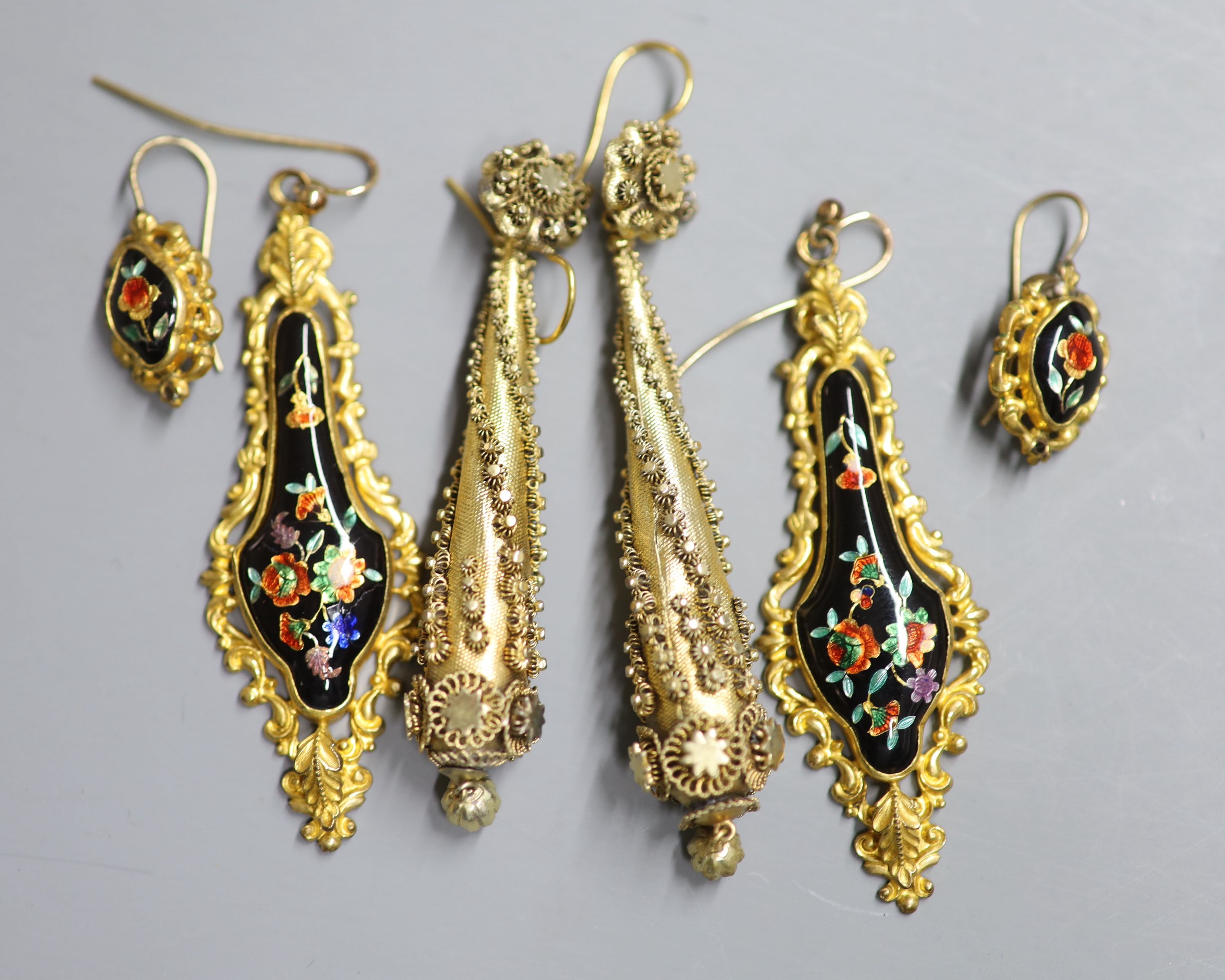 A pair of ornate Victorian gilt metal teardrop shaped earrings, 86mm and two later pairs.